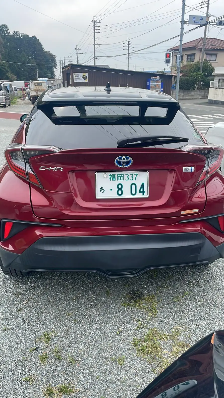 赤のトヨタ C-HR ハイブリッドのリアビュー